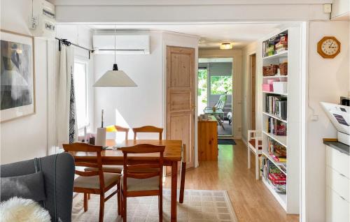 a dining room and living room with a table and chairs at Nice Home In Bjällebäck With Wifi in Bjällebäck