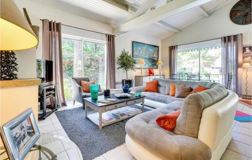 a living room with a couch and a table at Lovely Home In Sainte-Marie-De-Ré in La Flotte
