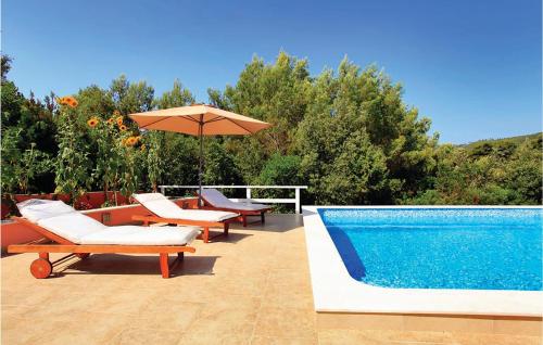a swimming pool with lounge chairs and an umbrella at Holiday Home Smokvica Smokvica in Smokvica