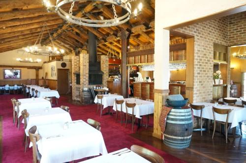 a dining room with white tables and chairs at Mahogany Park in Cranbourne