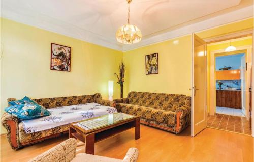 a living room with a couch and a table at 1 Bedroom Beautiful Apartment In Bakar in Bakar