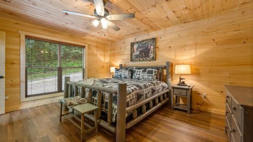 a bedroom with a bed in a log cabin at Star Ridge Cabin in Sevierville