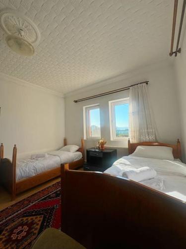 a bedroom with two beds and a window at Kesen Cappadocia House in Ürgüp