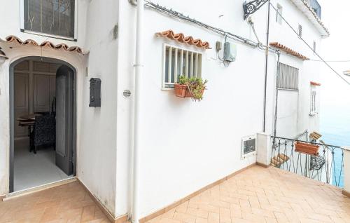 a white house with an open door and a balcony at Beautiful Apartment In Raito With Wifi in Albori