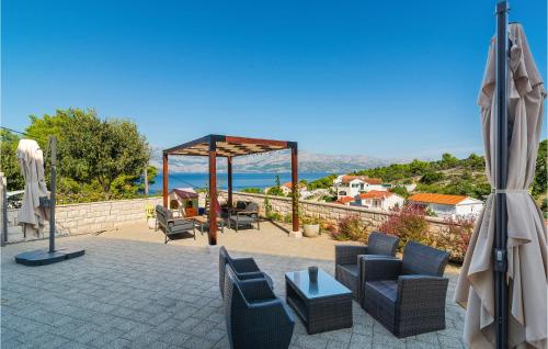 a patio with chairs and a gazebo at Gorgeous Home In Postira in Postira