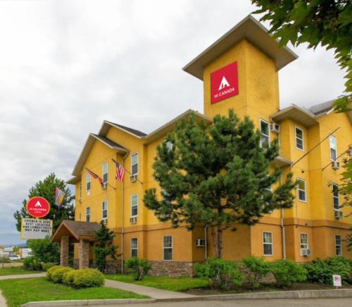 a large yellow building with aania sign on it at HI Kelowna Hostel in Kelowna