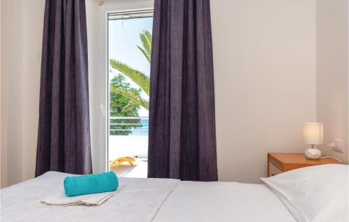 a bedroom with a bed and a large window at Holiday Home Zuljana 21 in Žuljana