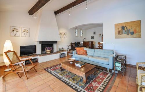 un salon avec un canapé bleu et une cheminée dans l'établissement Beautiful Home In Gonfaron, à Gonfaron