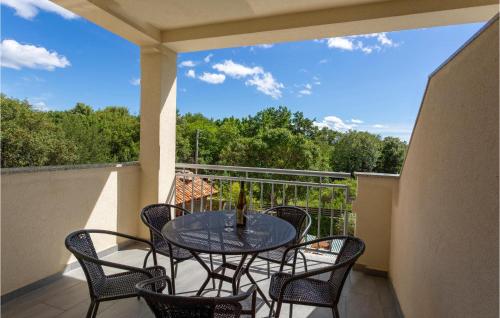a patio with a table and chairs on a balcony at Beautiful Apartment In Pinezici in Pinezici