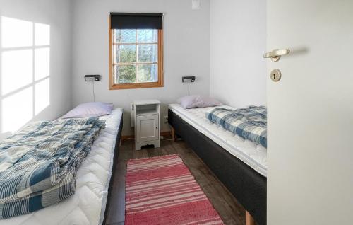 two beds in a small room with a window at 2 Bedroom Beautiful Home In Gislaved in Våthult