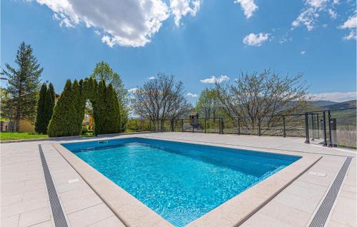 a swimming pool in the middle of a yard at Two-Bedroom Holiday Home In Kijevo in Kijevo