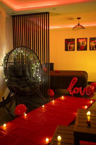 a living room with a chair and a couch with lights at Love Room, Luna Spa in Saint-Ouen-lʼAumône