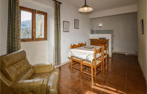 a living room with a table and a couch at Cozy Apartment In Carcheto Brustico in Carcheto