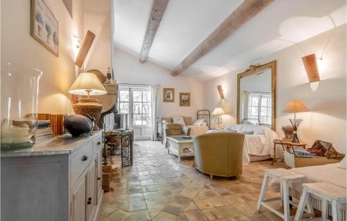 a kitchen and living room with a bed and a living room at Belle Maison À Lacoste in Lacoste