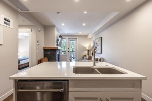 a kitchen with a sink and a counter at New 1Bd Luxe King Suite with Superb Mtn View in Canmore