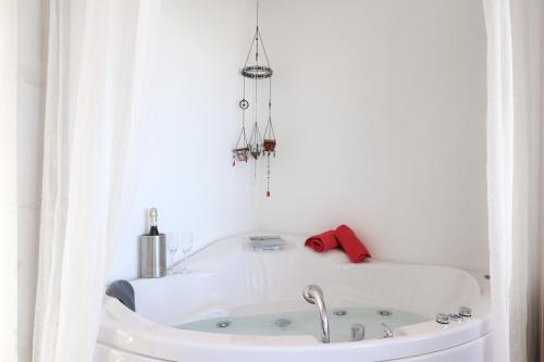 a white bath tub in a white room at Roussa Village in Sitia
