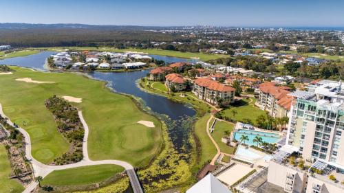 an aerial view of the golf course at the resort at Golfer's Paradise - Pelican Waters in Pelican Waters