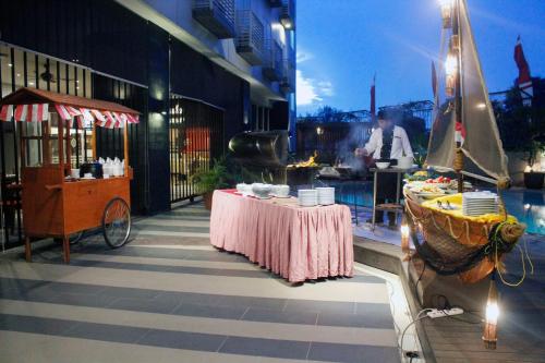 a restaurant with a table with dishes on it at Nagoya Mansion Hotel and Residence in Nagoya