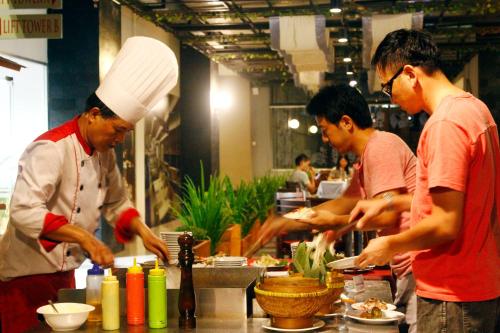 a group of men preparing food in a kitchen at Nagoya Mansion Hotel and Residence in Nagoya