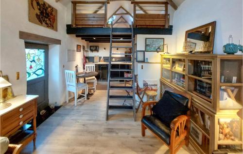 a living room with a loft bed and a desk at 1 Bedroom Cozy Home In Plouézec in Plouézec
