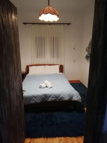 a bedroom with a bed with two towels on it at Παραδοσιακο σπιτι με εσωτερικο τζακι in Chrysomiléa