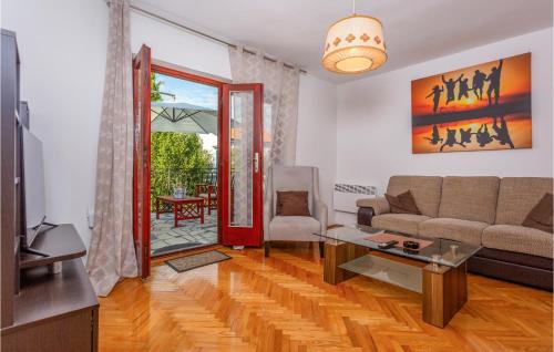 a living room with a couch and a table at 4 Bedroom Pet Friendly Home In Malinska in Malinska