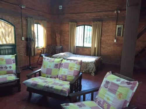 ein Schlafzimmer mit einem Bett, einer Couch und einem Sessel in der Unterkunft Paraje del molino Loft in Colón