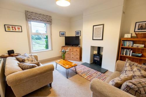 a living room with two couches and a tv at RIDGEMOUNT APT - Great base for walking and cycling in Keswick, Lake District National Park in Keswick