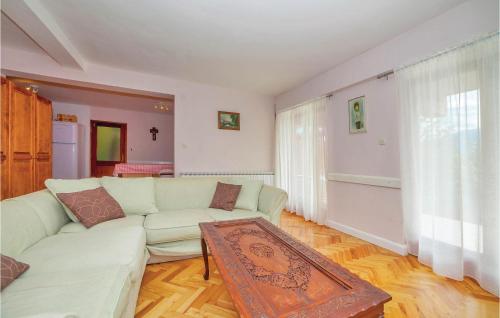 a living room with a white couch and a table at 7 Bedroom Pet Friendly Home In Crni Kal in Crni Kal