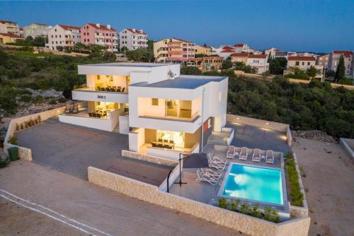 an aerial view of a house with a swimming pool at Villa Domenica - Luxury Apartment with Pool, Hot Tub & Sea View in Novalja
