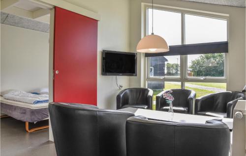 a conference room with black chairs and a red wall at Holiday Home Halvejen Hytte Spjald Ii in Spjald