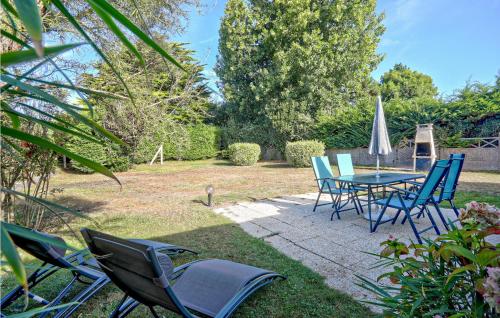eine Terrasse mit Tisch und Stühlen in einem Hof in der Unterkunft Amazing Home In Anneville Sur Mer in Anneville-sur-Mer