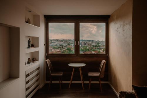 a room with a table and chairs and a window at Loronobeo.forest in Belgrade