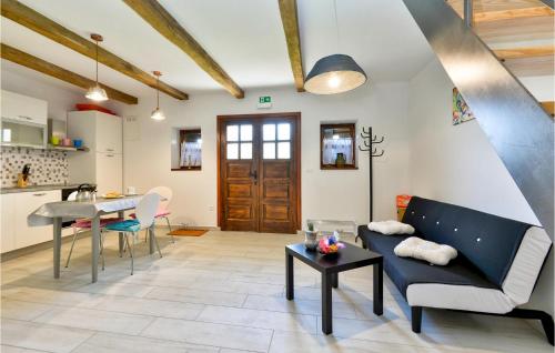 a living room with a couch and a table at Awesome Home In Breznicki Hum in Donje Makojišće