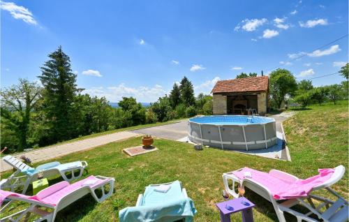 a group of lawn chairs and a swimming pool at Awesome Home In Breznicki Hum in Donje Makojišće