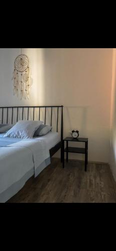 a bedroom with a bed with a chandelier and a table at Brioni House in Ribare