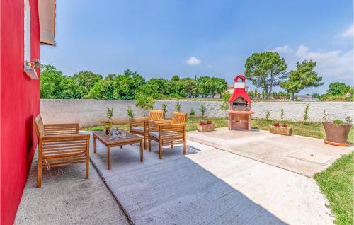 a patio with a table and chairs and a grill at One-Bedroom Holiday Home In Hreljici in Hreljići