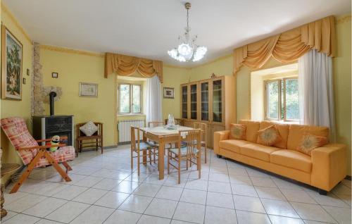 a living room with a couch and a table at Nice Home In Castelnuovo Di Farfa in Castelnuovo di Farfa