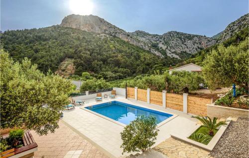 a swimming pool with a mountain in the background at 1 Bedroom Awesome Apartment In Klek in Klek