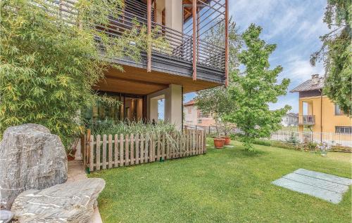 a house with a wooden fence in a yard at Gorgeous Home In Borgo San Dalmazzo Cn in Borgo San Dalmazzo