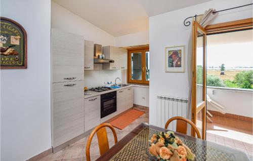 a kitchen with a glass table and a counter top at 2 Bedroom Cozy Home In Sabaudia in Sabaudia