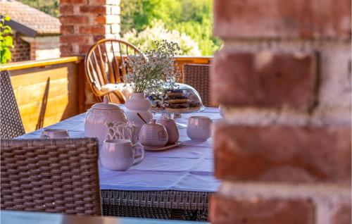 a table with vases and flowers on top of it at Lovely Home In Bosiljevo With Kitchen in Bosiljevo