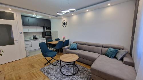 a living room with a couch and a table at Afrodita Lux East Sarajevo in Lukavica