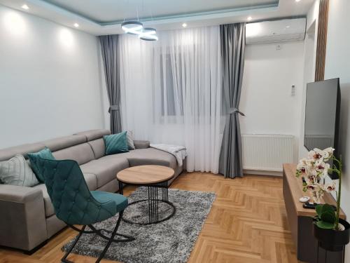 a living room with a couch and a table at Afrodita Lux East Sarajevo in Lukavica