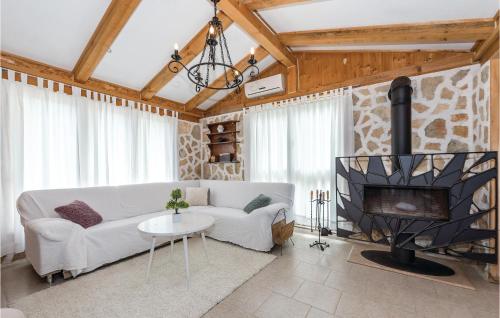 a living room with a couch and a fireplace at One-Bedroom Holiday Home In Danilo in Danilo Biranj