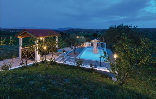 a house with a swimming pool and a gazebo at One-Bedroom Holiday Home In Danilo in Danilo Biranj