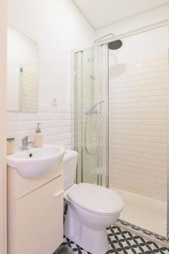 a bathroom with a toilet and a sink and a shower at Oporto Seside Village - Casa Mar in Matosinhos