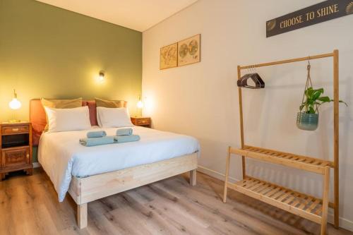 a bedroom with a bed with two towels on it at Oporto Seside Village - Casa Mar in Matosinhos