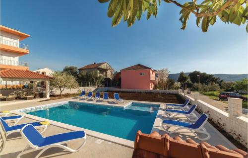 a swimming pool with chaise lounge chairs and a swimming pool at Nice Apartment In Poljica in Poljica