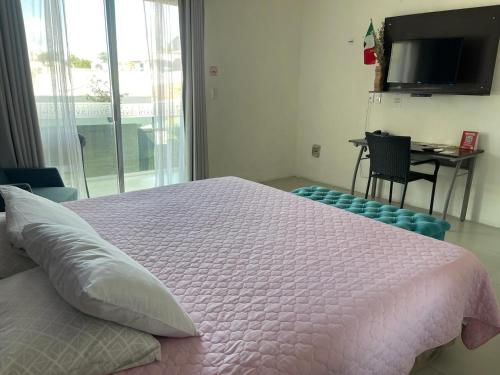 Ένα ή περισσότερα κρεβάτια σε δωμάτιο στο Hotel Villa Escondida Campeche